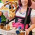 Munich, Bavaria, Germany September 19, 2026: A server wearing a dirndl presents a large Oktoberfest pretzel with cheese