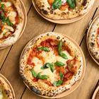 A,Top,View,Of,Different,Gourmet,Pizzas,On,A,Wooden