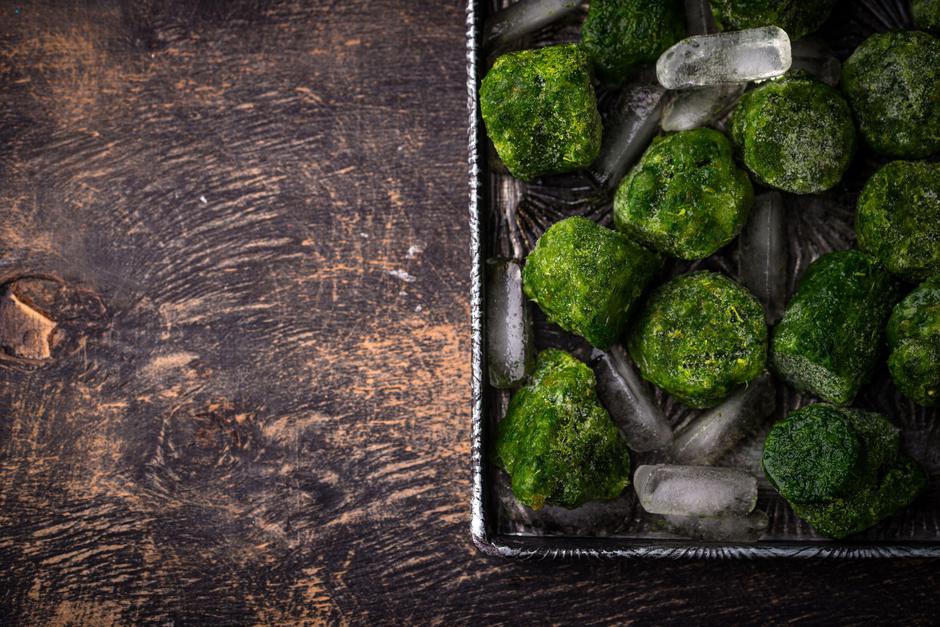 Frozen spinach green cubes in bowl | Author: Profimedia