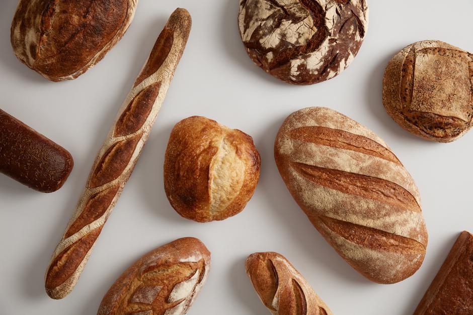 Assortment of different types of bread, loaf, baguettes, made of wheat, rye organic flour on leaven, isolated on white background. Bakery and healthy food concept. Natural biologial products. | Author: wayhomestudio/Unsplash