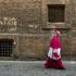 A Catholic bishop walks in a back street in Rome